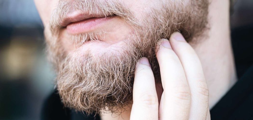 closeup-young-man-touches-his-beard-with-his-hand (1)