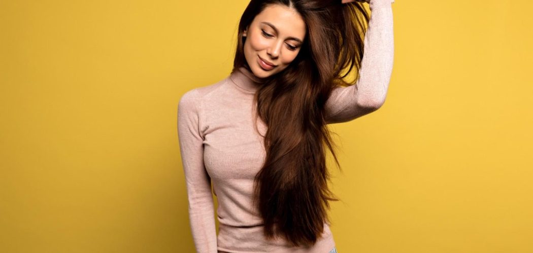 pacified-girl-pink-pullover-straightens-her-hair (1)