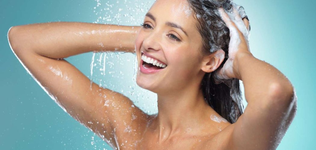 practice-excellent-body-hygiene-shot-young-woman-washing-her-hair-shower-against-blue-background (1)